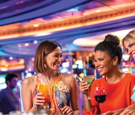  Three women having fun at cocktail bar