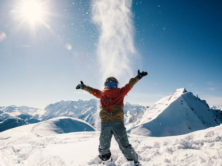 Skier throwing snow into air