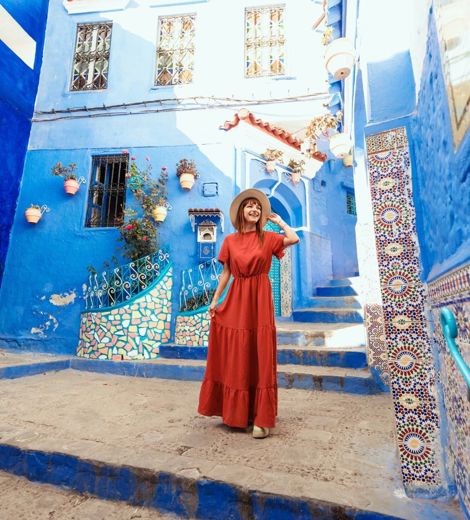 Woman surrounded by blue buildings