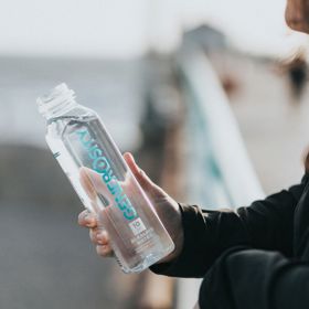 Person holding plastic water bottle