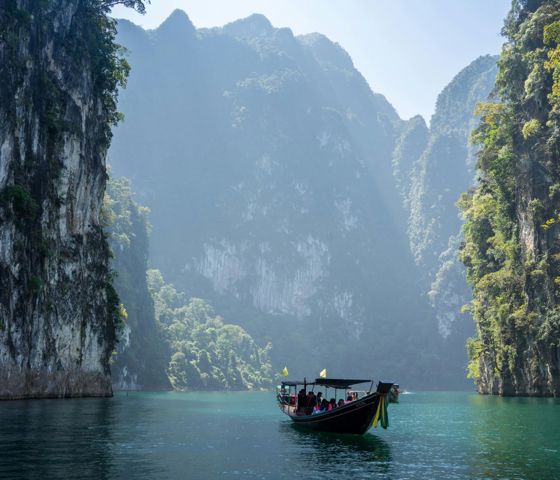 Boat on the water travelling in Khao Sok National Park