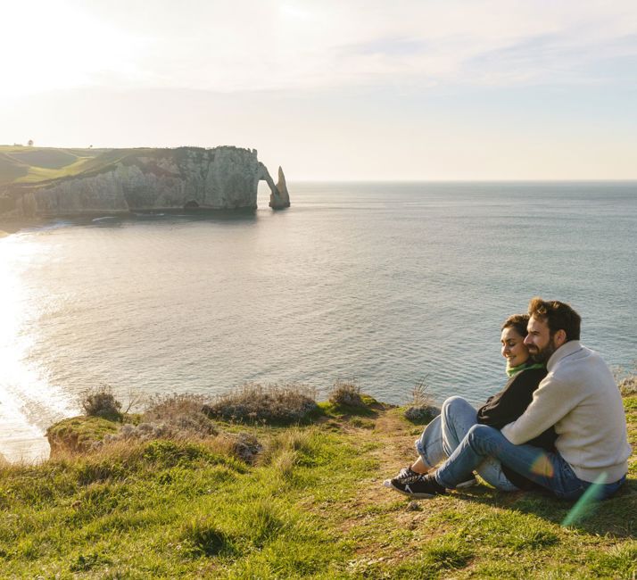 People sitting overlooking view of Normandy
