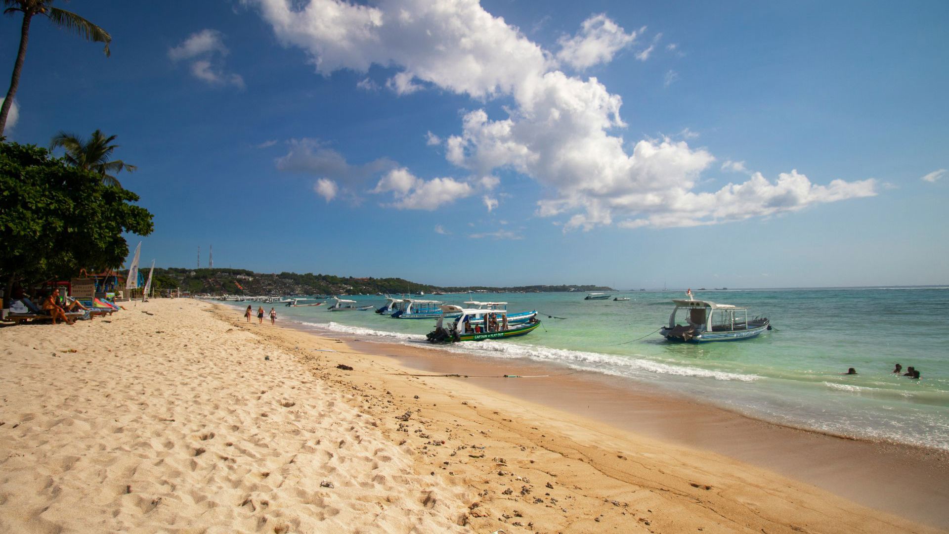 Boats docking on a beach on a sunny day in Bali - Image credit: Unsplash/Tarryn Myburgh