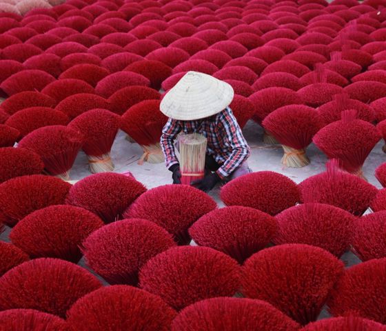 Asia Vietnam woman making red incense 