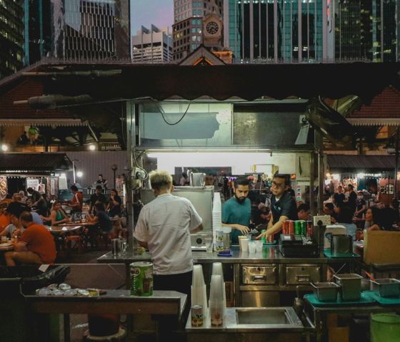 ethan-hu-NRTptNBkLLw-unsplash-singapore-hawker-stalls-man-cooking-busy-street-crowd